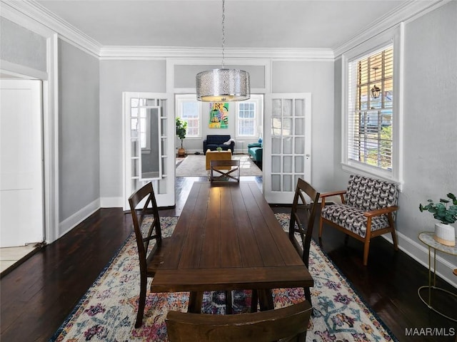 dining room with a healthy amount of sunlight, crown molding, and french doors