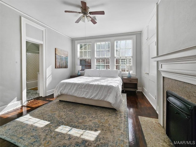 bedroom with ceiling fan, dark hardwood / wood-style floors, and ornamental molding