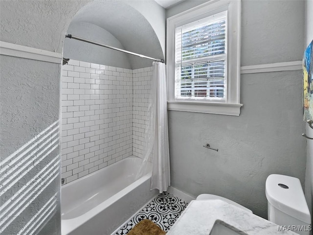 bathroom with shower / bath combo with shower curtain