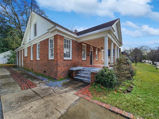 view of home's exterior featuring a porch and a yard