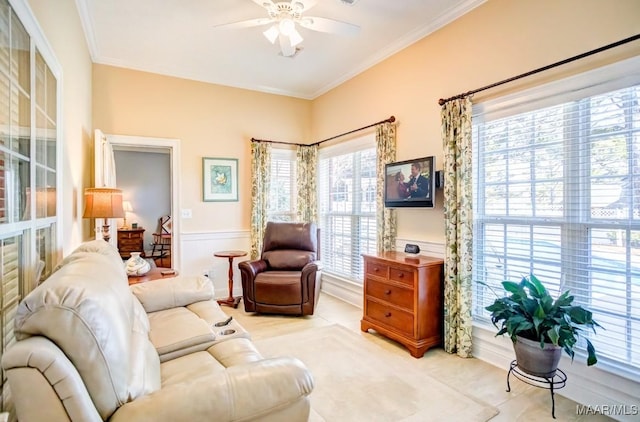 living room featuring crown molding and ceiling fan