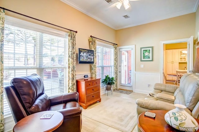 living room with light tile patterned floors, plenty of natural light, ceiling fan, and crown molding