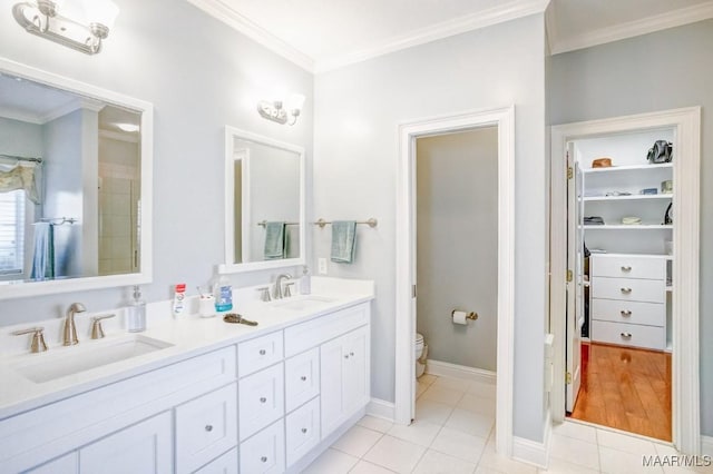 bathroom with crown molding, tile patterned flooring, vanity, and toilet