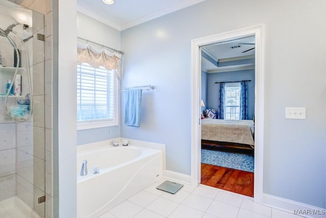 bathroom featuring tile patterned flooring, independent shower and bath, a wealth of natural light, and ornamental molding