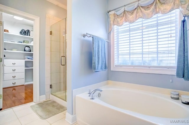 bathroom with tile patterned flooring and independent shower and bath