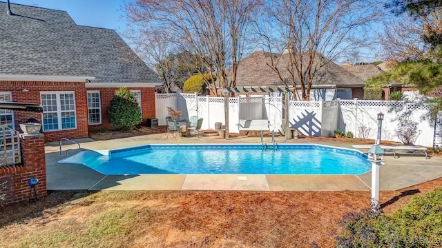 view of pool featuring a diving board and a patio