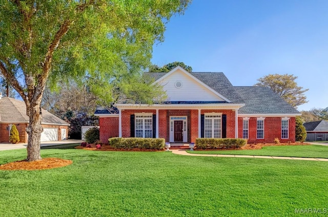 view of front of property with a front yard and a garage