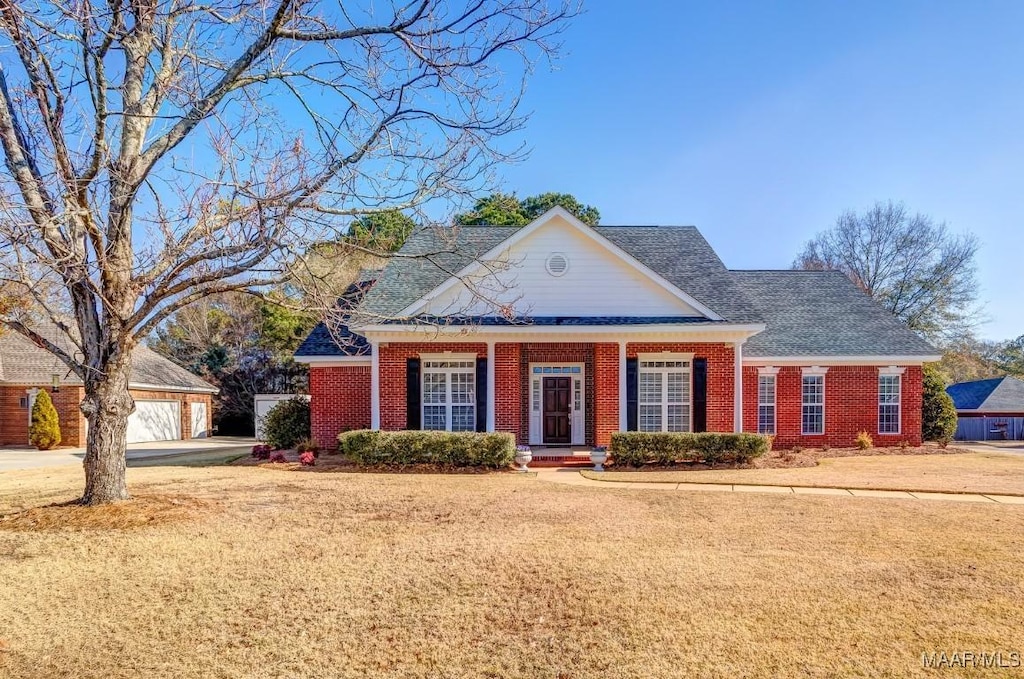 view of front of house with a garage and a front lawn