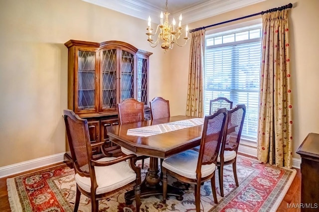 dining space with hardwood / wood-style floors, a chandelier, and ornamental molding