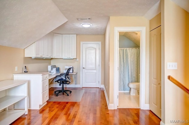 office featuring light hardwood / wood-style flooring and a textured ceiling