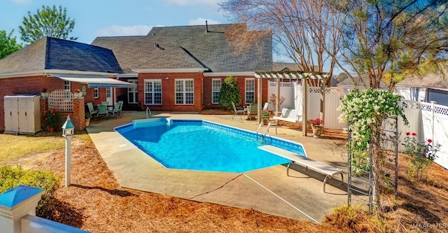 view of swimming pool with a diving board, a patio area, and a pergola