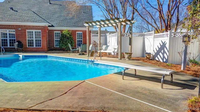 view of pool featuring a diving board and a patio area