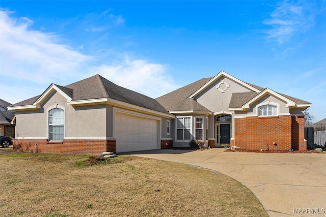 view of front of property featuring a garage and a front lawn