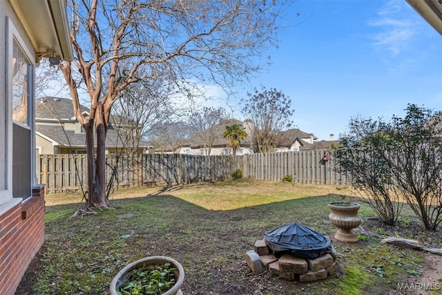 view of yard with a fire pit