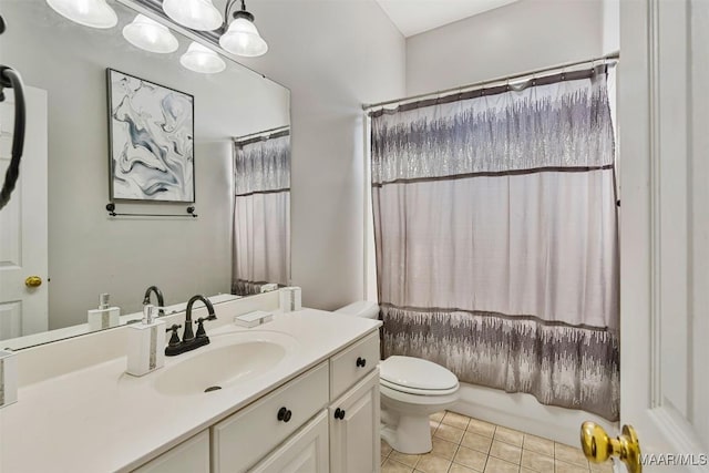 bathroom with tile patterned flooring, vanity, and toilet