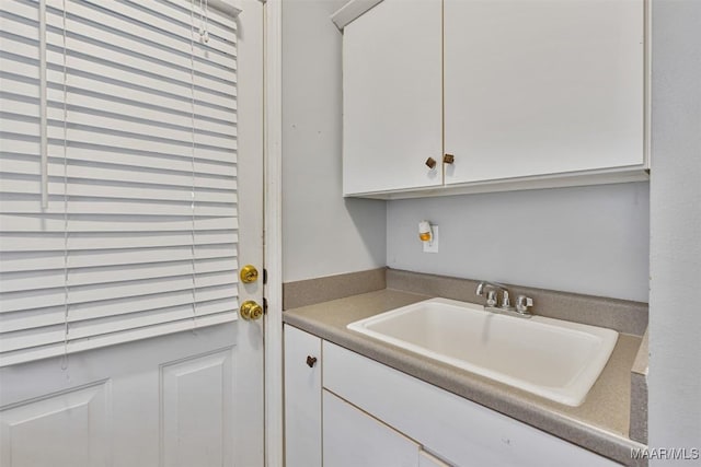 clothes washing area featuring sink