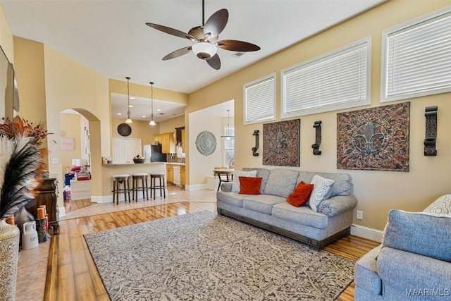 living room featuring light hardwood / wood-style flooring and ceiling fan