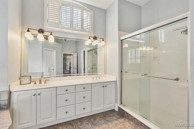 bathroom featuring tile patterned flooring, vanity, and an enclosed shower