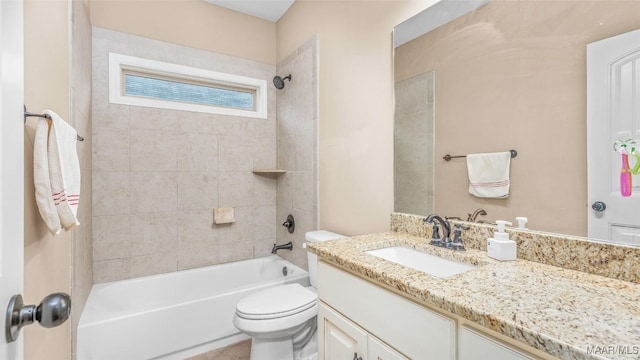 full bathroom featuring vanity, toilet, and tiled shower / bath