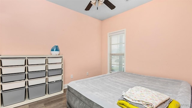 bedroom with ceiling fan and dark hardwood / wood-style floors