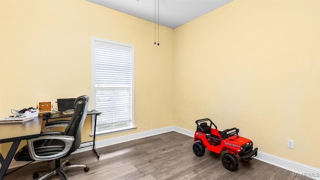 office space with wood-type flooring