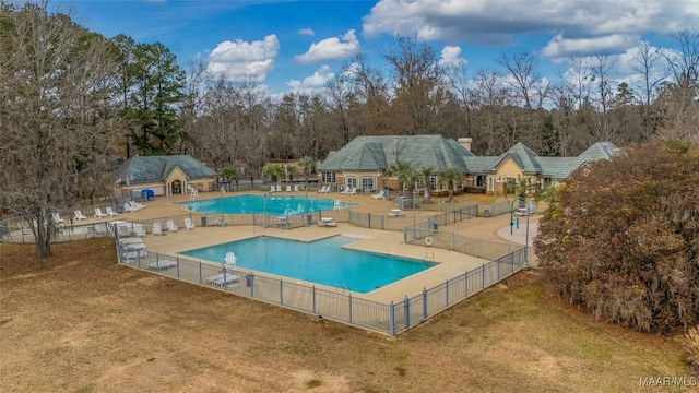 view of swimming pool with a patio area and a yard