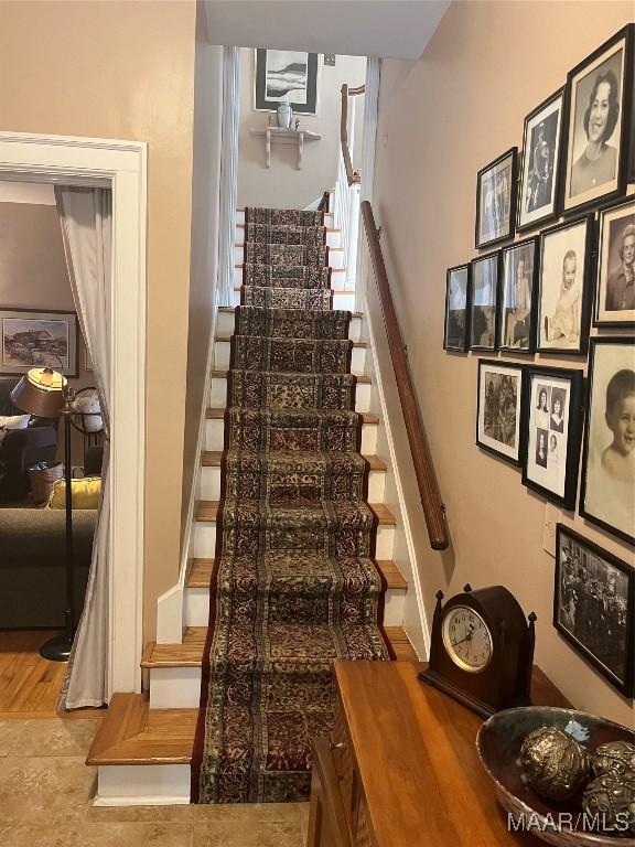 stairway featuring tile patterned floors