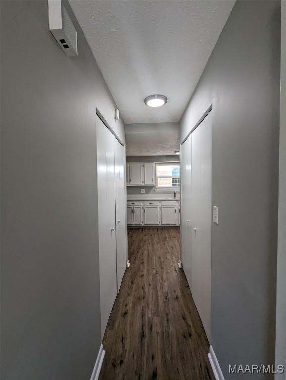 corridor featuring dark hardwood / wood-style flooring