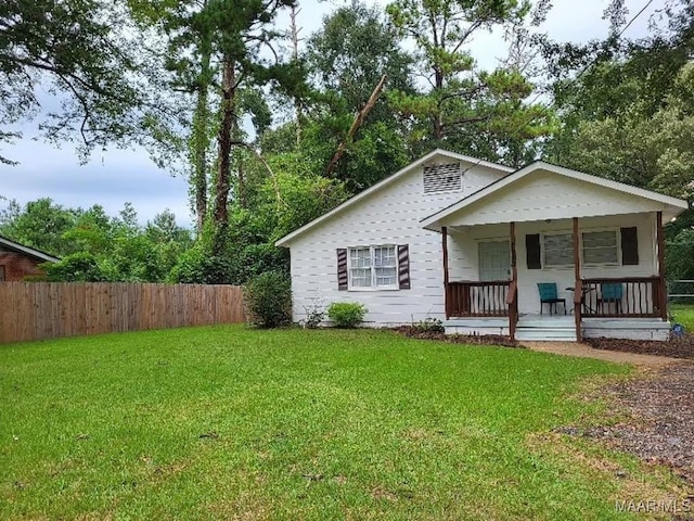 view of front of home with a porch and a front lawn