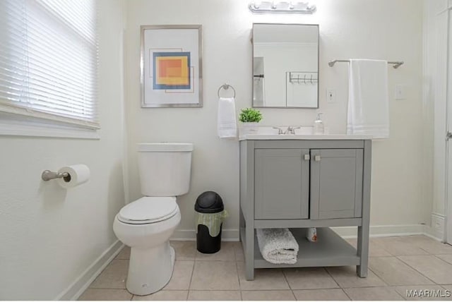 bathroom featuring tile patterned flooring, vanity, and toilet