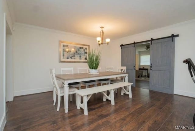 dining room featuring a barn door, crown molding, dark hardwood / wood-style flooring, and a chandelier