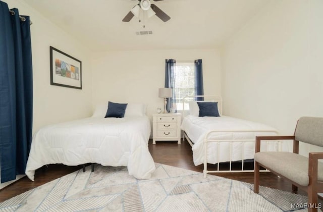 bedroom featuring ceiling fan and dark wood-type flooring