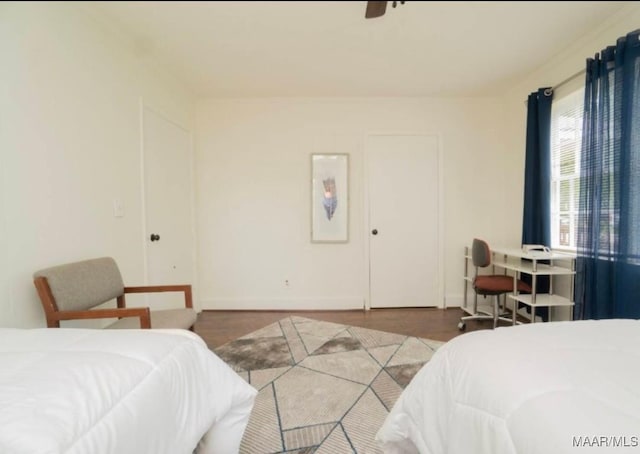 bedroom featuring ceiling fan and dark wood-type flooring