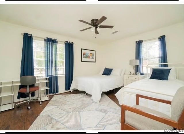 bedroom with ceiling fan and wood-type flooring