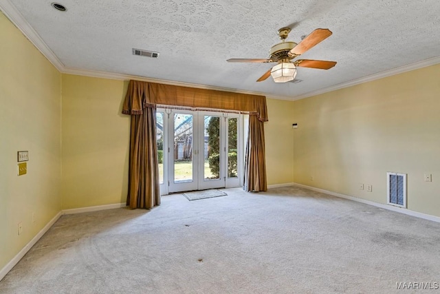 empty room with light carpet, a textured ceiling, ceiling fan, and crown molding