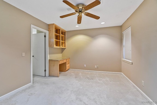 carpeted spare room featuring ceiling fan