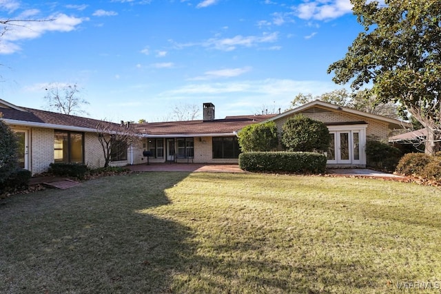 back of house with a lawn and french doors