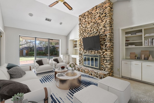 living room featuring a stone fireplace, ceiling fan, built in features, and high vaulted ceiling