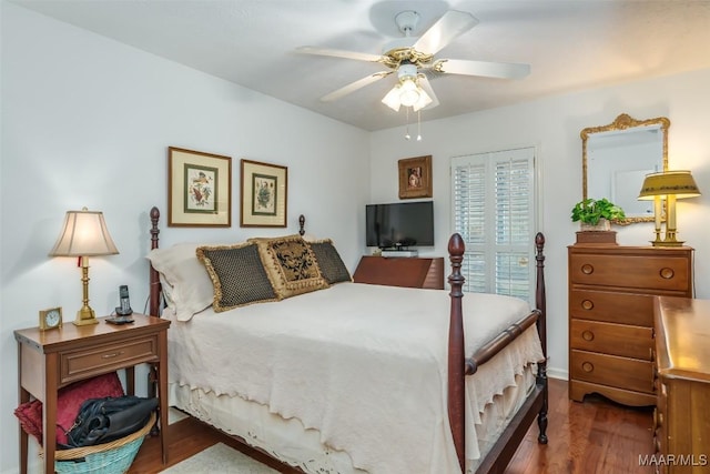 bedroom with ceiling fan and dark hardwood / wood-style floors