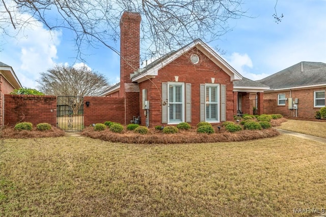 view of side of home with a yard