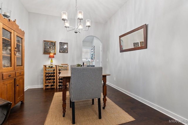 dining area with a notable chandelier and dark hardwood / wood-style floors