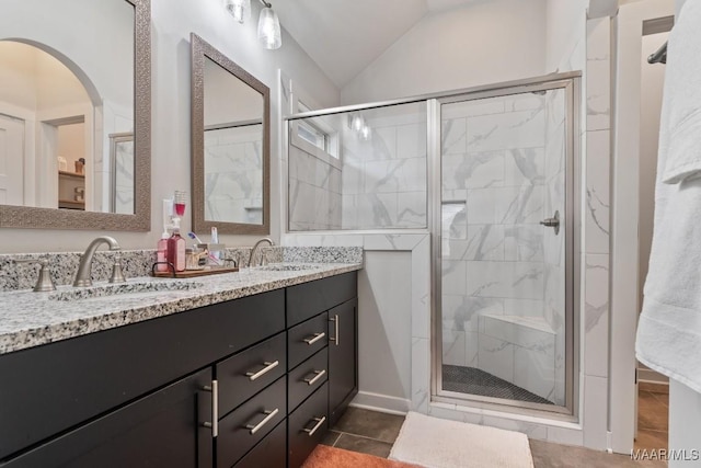 bathroom featuring tile patterned floors, vanity, walk in shower, and vaulted ceiling