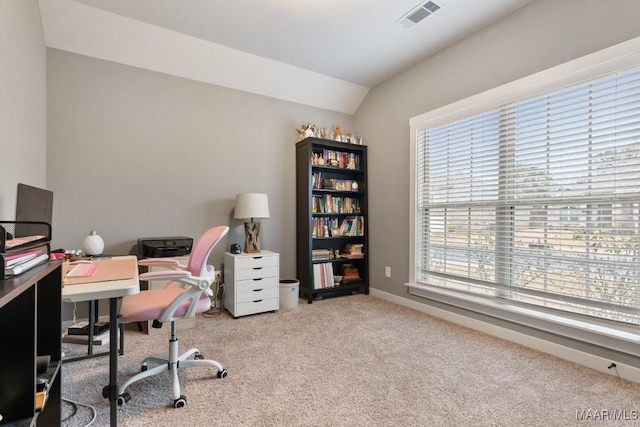 carpeted office space featuring vaulted ceiling and a wealth of natural light