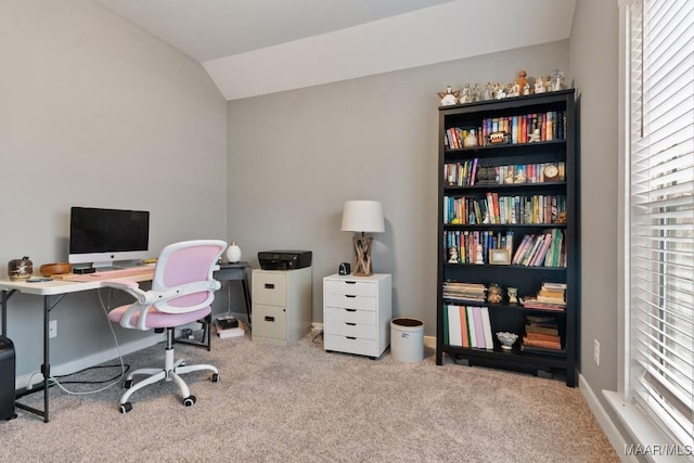 office space with lofted ceiling and light carpet