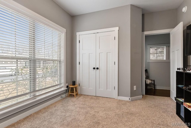 bedroom featuring carpet, multiple windows, and a closet