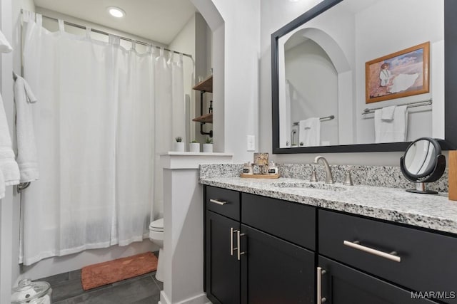 full bathroom featuring tile patterned floors, vanity, toilet, and shower / bathtub combination with curtain