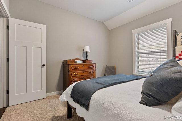 carpeted bedroom with vaulted ceiling