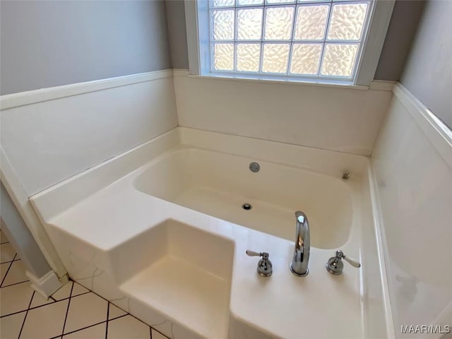 bathroom featuring a tub to relax in and tile patterned floors