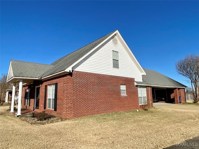 view of property exterior featuring a yard and a carport