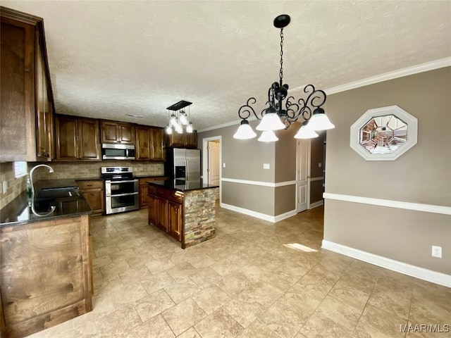 kitchen featuring backsplash, stainless steel appliances, sink, a chandelier, and hanging light fixtures